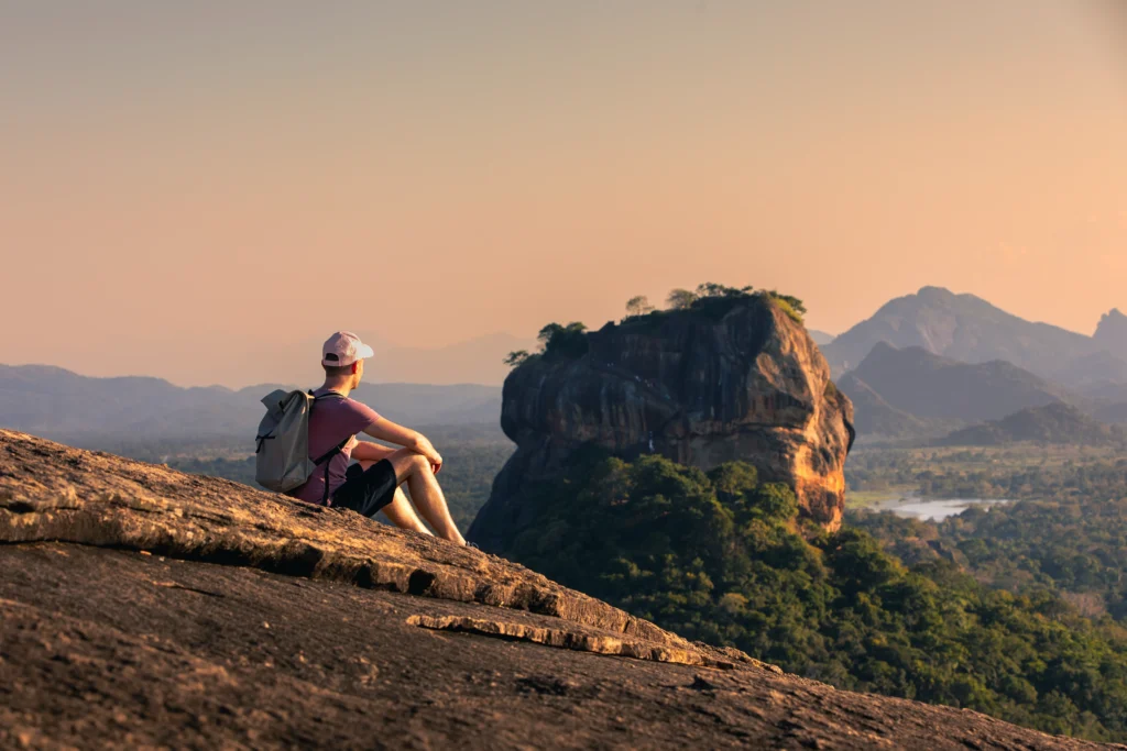 man-with-backpack-sitting-on-rock-and-looking-at-l-2025-02-16-11-57-02-utc